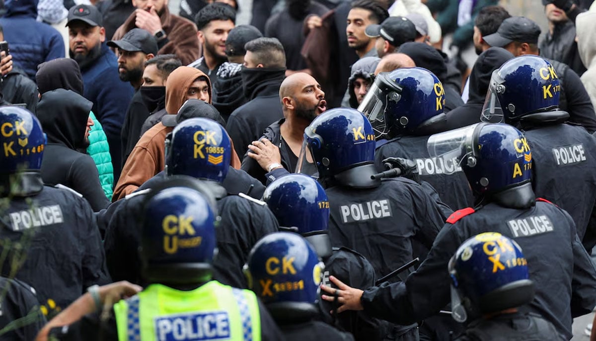 People confront police officers during a protest in Bolton, Britain, August 4, 2024. — Reuters