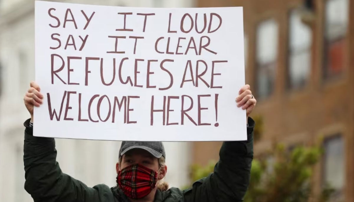 A person holds a placard supporting the arrival of refugees in the UK. — Reuters/File