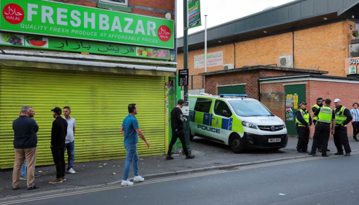 Police officers stand guard next to a closed shop during a counter protest ahead of an anti-immigration protest, in Derby, Britain, August 7, 2024. — Reuters