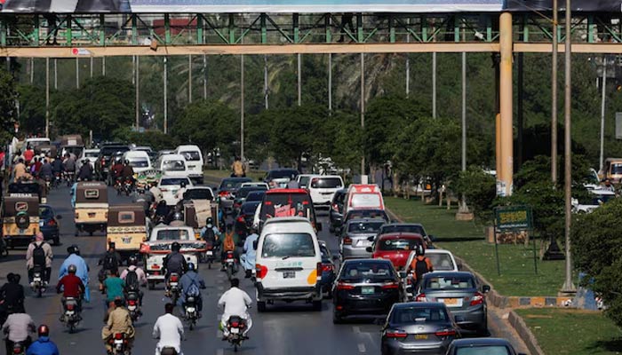 Representational image of vehicles moving past a pedestrian bridge in Karachi, April 22, 2024. — Reuters