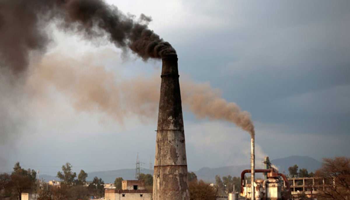 Smoke rises from the smoke stacks of asphalt and brick factories burning coal, old shoes and oil extracted from tyre rubber and plastic in Islamabad, March 9, 2017. — Reuters