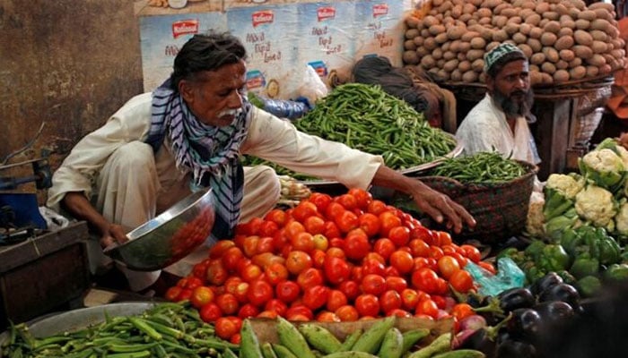 Men sell vegetables at their makeshift stalls at the Empress Market in Karachi, Pakistan April 2, 2018. — Reuters