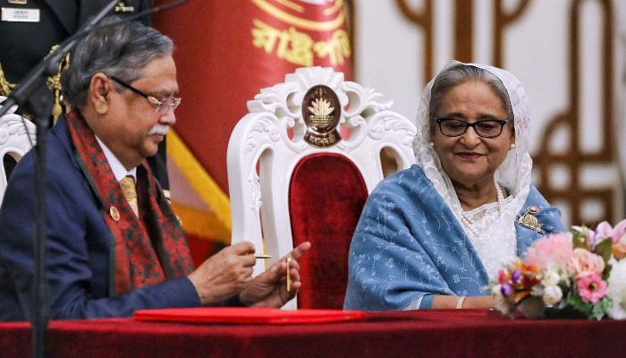 Bangladeshi President Mohammed Shahabuddin (L) administers Sheikh Hasinas oath-taking ceremony as the countrys prime minister in Dhaka, Bangladesh on January 11, 2024. — Reuters