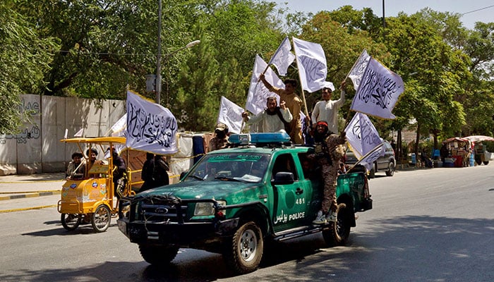 Members of the Taliban carrying flags participate in a rally to mark the third anniversary of the fall of Kabul, in Kabul, Afghanistan, August 14, 2024. — Reuters