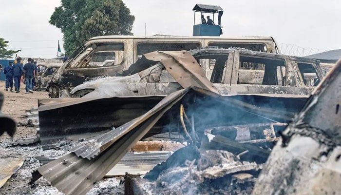 Cars parked at the front of the prison were burnt during the jail-break Kinshasa, DR Congo. — Reuters/File