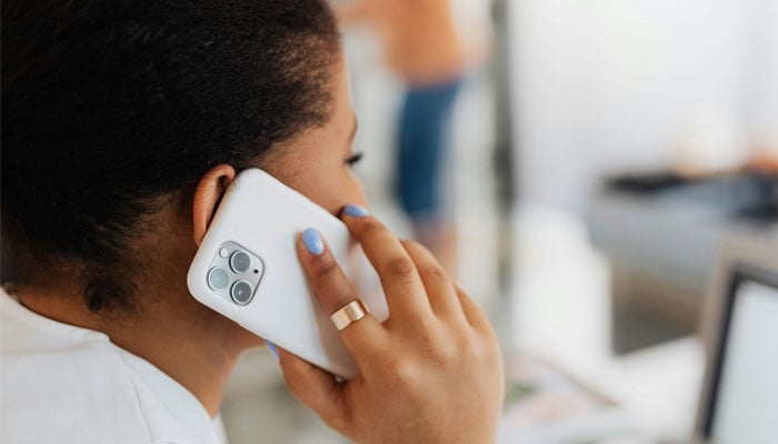 A representational image of a woman talking on the phone. — Pexels