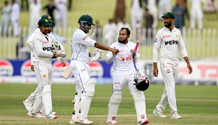 Bangladeshs Mushfiqur Rahim (2nd right) and Shakib Al Hasan (third right) celebrate after their teams win at the second Test match against Pakistan, in Rawalpindi Cricket Stadium on September 3, 2024. —AFP