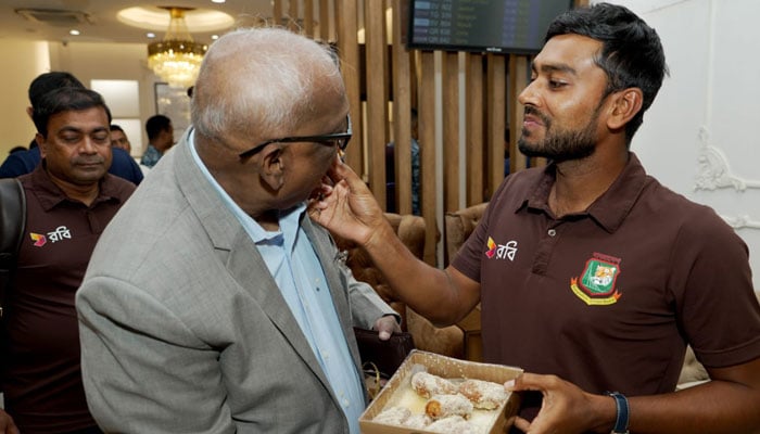 A Bangladeshi player offers sweets to a BCB official upon return to the country following the teams historic win against Pakistan in this image released on September 5, 2024. — Facebook/@bcbtigercricket