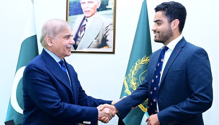 Prime Minister Shehbaz Sharif shakes hands with Pakistans newly-appointed Ambassador-at-Large for Youth Empowerment Israr Khan Kakar. — Photo by author