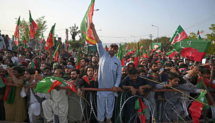 Supporters of PTI attend a rally being addressed by former prime minister Imran Khan, in Islamabad on March 27, 2022. — AFP