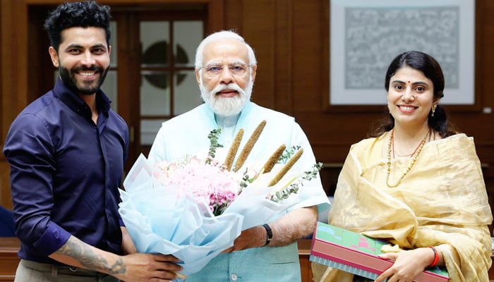 India all-rounder Ravindra Jadeja (Left) along with his wife Rivaba Ravindrasinh Jadeja (Right) presenting flower bouquet to Indian Prime Minister Narendra Modi on May 16, 2023. — Facebook/Rivaba Ravindrasinh Jadeja