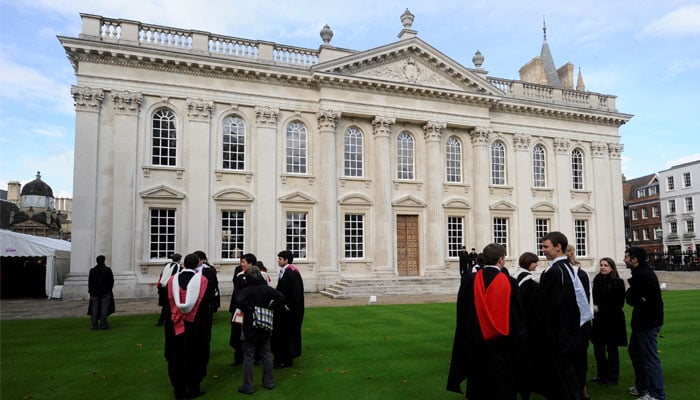 Graduates gather outside Senate House after their graduation ceremony at Cambridge University in eastern England. — Reuters/File