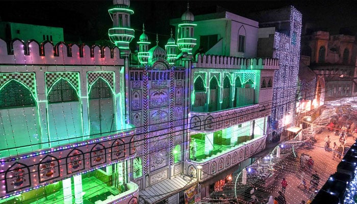 People walk in a street decorated to mark Eid Milad un Nabi in Lahore. — AFP/File