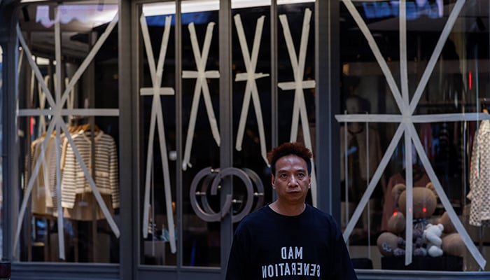 A window is taped in anticipation of typhoon Yagi at a clothing store in Hong Kong, China on September 5, 2024. — Reuters