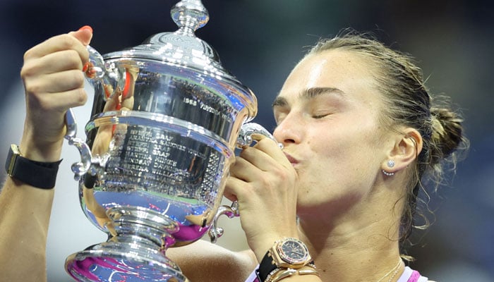 Belarus’s Aryna Sabalenka kisses the trophy after defeating USA’s Jessica Pegula during their women’s final match on day thirteen of the US Open tennis tournament at the USTA Billie Jean King National Tennis Center in New York City, on September 7, 2024. — AFP