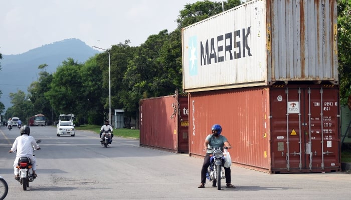 A view of heavy shipping containers placed on the periphery of a road near red zone area, due to security reasons, in Islamabad on September 6, 2024. — Online