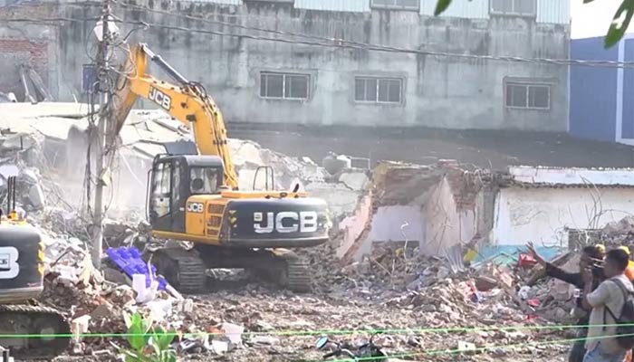 An excavator is seen near the site of building collapse in Lucknow in this screengrab taken from a video. — PTI_News/X