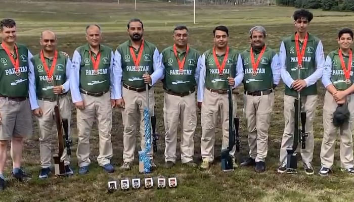 Pakistani shooters pose for a group photo with their rifles and medals won at Long-Range Shooting Championship in UK. — Reporter/File