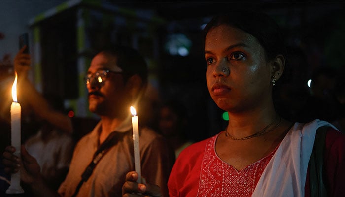 People participate in a candlelight vigil at a protest condemning and marking one month since the rape and murder of a trainee medic at a government-run hospital in Kolkata, India, September 8, 2024. — Reuters