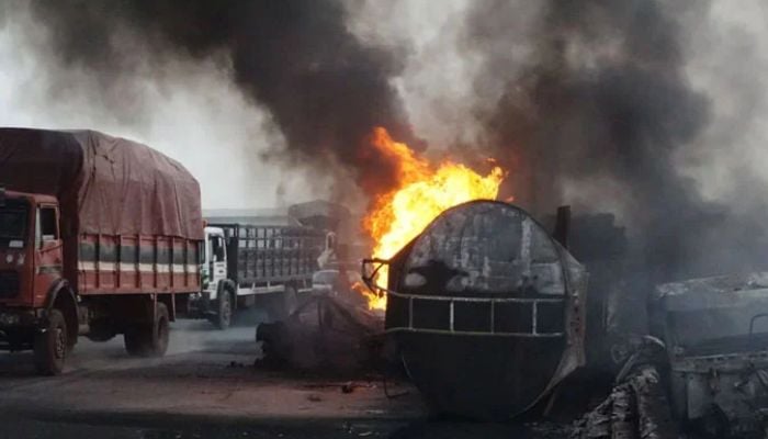 A representational image showing trucks driving past fuel-laden tanker which exploded and fell after a collision. — AFP/File