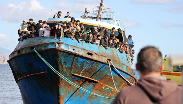 Migrants stand aboard a fishing boat in the port of Paleochora, after a rescue operation off the coast of the island of Crete, Greece, November 22, 2022. — Reuters