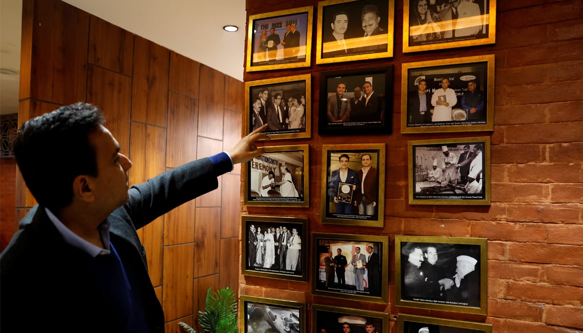 Moti Mahal Delux Managing Director Monish Gujral shows photographs of celebrities and politicians inside the restaurant in New Delhi, India, January 23, 2024. — Reuters