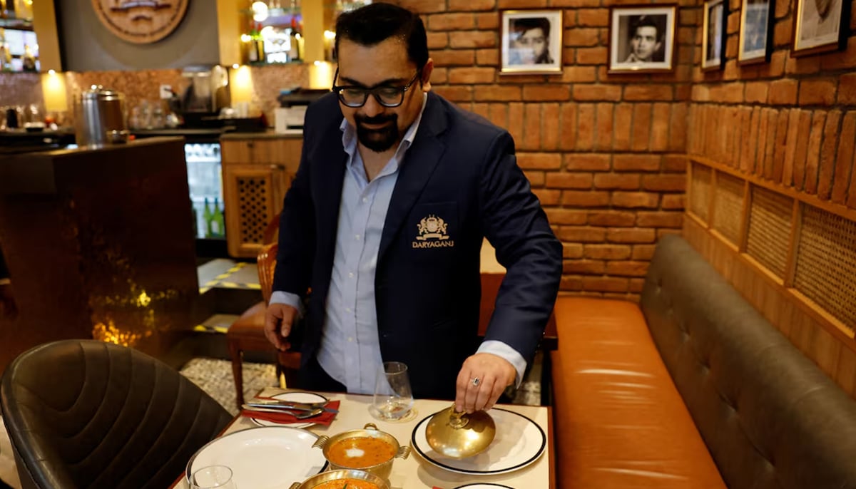 Amit Bagga, CEO of Daryaganj restaurant, shows a freshly prepared butter chicken dish and the lentil dish Dal Makhani inside Daryaganj restaurant at a mall, in Noida, India, January 23, 2024. — Reuters