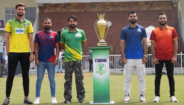 Captains of the Champions One-Day squads gesture for a photography along with the trophy. — PCB