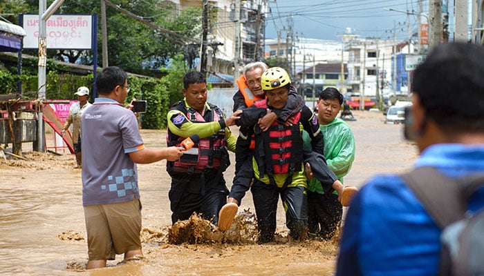 Rescue workers help stranded people from a flooded area at the border town of Mae Sai, following the impact of Typhoon Yagi, in the northern province of Chiang Rai, Thailand on September 11, 2024. — Reuters