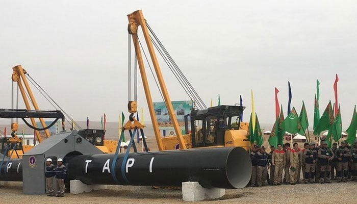 Workers attend the launching ceremony of construction work of the TAPI project on the Afghan section of a natural gas pipeline, near the town of Serhetabat, Turkmenistan, Feb 23, 2018. — Reuters