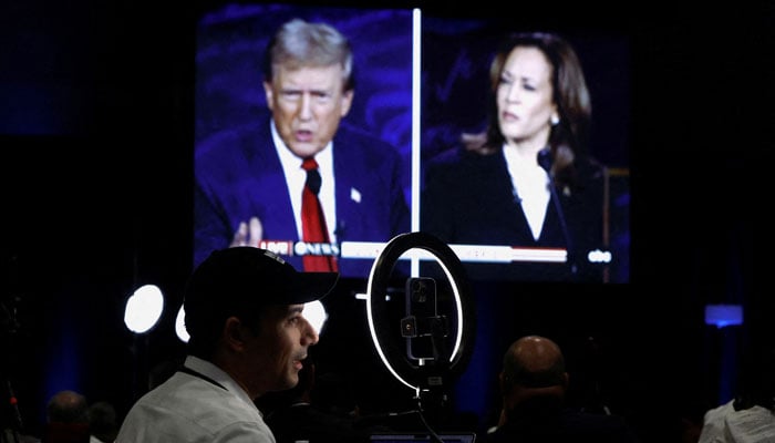 Members of the media use a screen to watch the presidential debate, as Republican presidential nominee, former US President Donald Trump and Democratic presidential nominee, US Vice President Kamala Harris attend a presidential debate hosted by ABC in Philadelphia, Pennsylvania, US, September 10, 2024. — Reuters