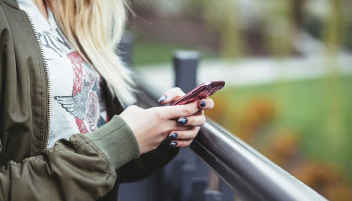 A representational image of a woman using a phone. — Unsplash