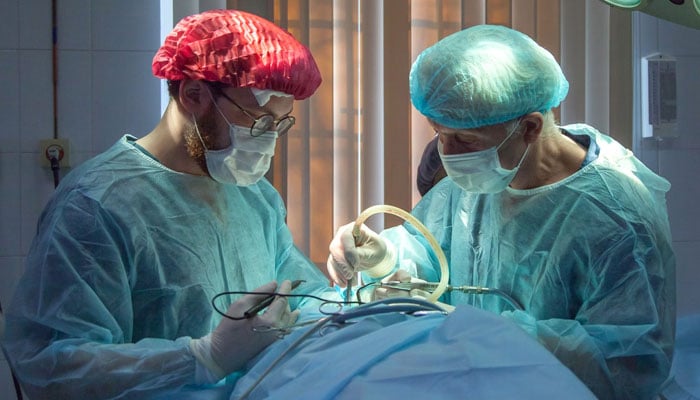 A representational image showing two dosctors performing a surgery. — Unsplash