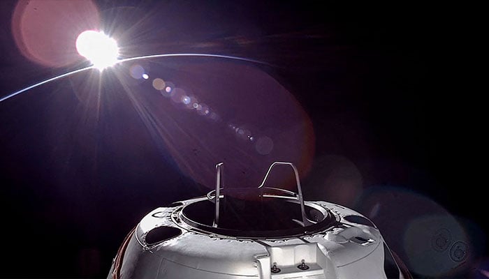 This handout picture courtesy of SpaceX and Polaris taken on September 12, 2024, shows an orbital sunset from the SpaceX Dragon capsule with a hatch structure called Skywalker, ahead of the first private spacewalk performed by the crew of the SpaceX Polaris Dawn mission. — AFP