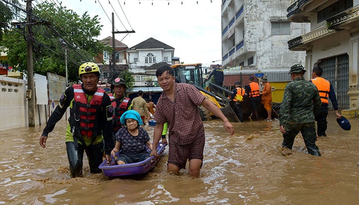 Rescue workers help a stranded woman from a flooded area at the border town of Mae Sai, following the impact of Typhoon Yagi, in the northern province of Chiang Rai, Thailand on September 12, 2024. — Reuters