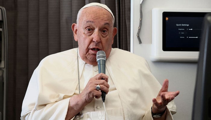 Pope Francis holds a news conference aboard the papal plane on his flight back after his 12-day journey across Southeast Asia and Oceania, on September 13, 2024. — AFP