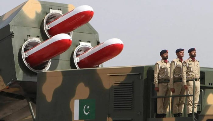 Pakistani army soldiers stand atop a military vehicle carrying missiles Babur during the Pakistan Day parade in Islamabad on March 23, 2022. — AFP