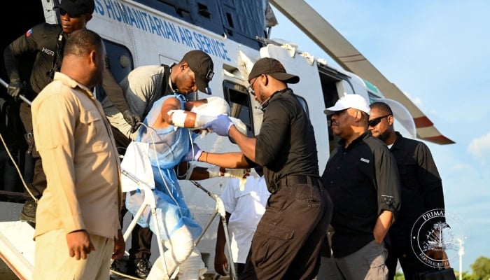 Haiti PM Garry Conille looks on, as an injured victim who was evacuated to receive medical care following a fuel truck explosion exits a helicopter, in Port-au-Prince, Haiti, September 14, 2024. — Reuters