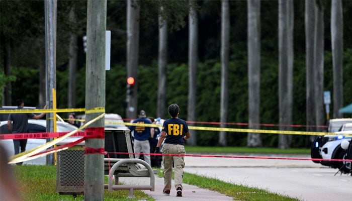 Members of FBI are seen at the crime scene outside the Trump International Golf Club in West Palm Beach, Florida, on September 15, 2024 following a shooting incident at former US president Donald Trump´s golf course. — AFP