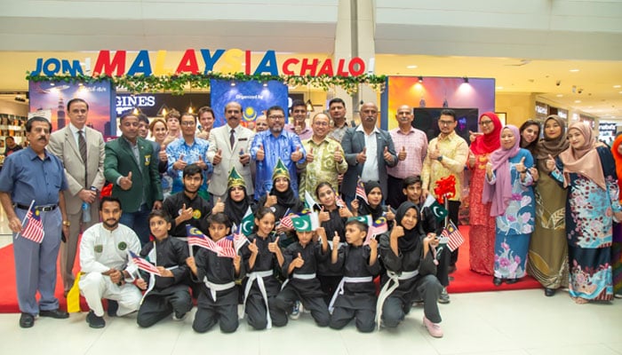 Herman Hardynata Ahmad, the consul general of Malaysia in Karachi, (centre) poses with participants and volunteers at the conclusion of Jom! Malaysia Chalo!  event at Dolmen Mall, Clifton, Karachi on September 15, 2024. — Facebook/Consulate-General of Malaysia in Karachi