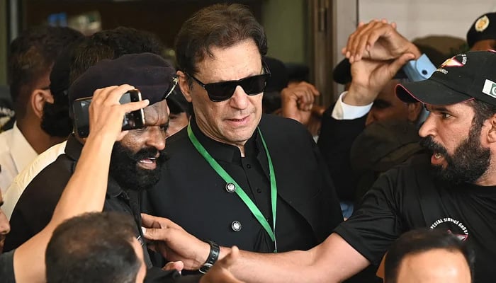 PTI founder Imran Khan (centre) leaves after appearing in the Supreme Court in Islamabad on July 24, 2023. — AFP