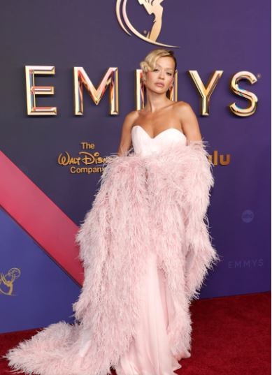 Rita Ora exuded refined elegance in a pale pink ensemble with a matching furry cape and gloves