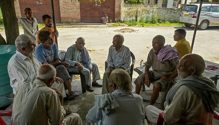 In this photograph taken on September 5, 2024, Hindu refugees from West Pakistan, speak while sitting outside their shops in Jammu. — AFP