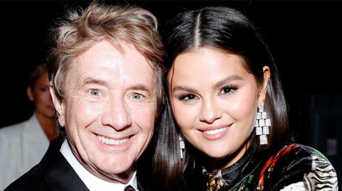 Martin Short whispers something sweet to Selena Gomez at the 2024 Emmys