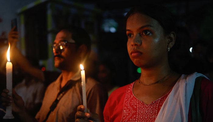 People participate in a candlelight vigil at a protest condemning and marking one month since the rape and murder of a trainee medic at a government-run hospital in Kolkata, India, September 8, 2024. — Reuters