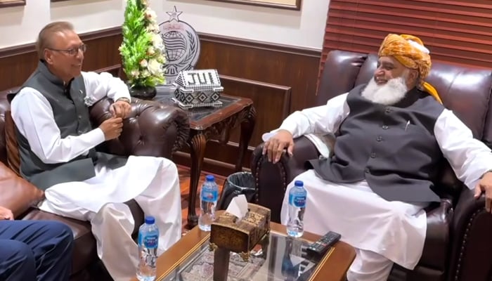 Former president and PTI leader Arif Alvi (left) meets JUI-F Chief Maulana Fazlur Rehman at his residence in Islamabad on September 17, 2024. — Screengrab via Geo News