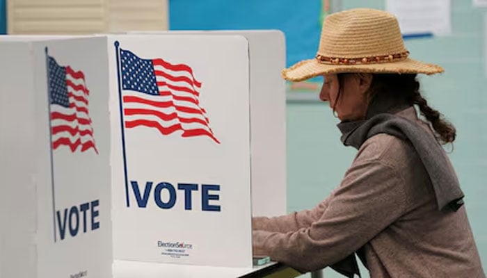 A voter casts her ballot at a polling station on Election Day in Falls Church, Virginia, US, November 7, 2023. — Reuters