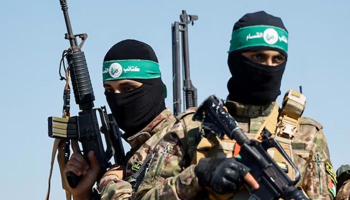 Palestinian fighters from the armed wing of Hamas take part in a military parade to mark the anniversary of the 2014 war with Israel, near the border in the central Gaza Strip, July 19, 2023. — Reuters