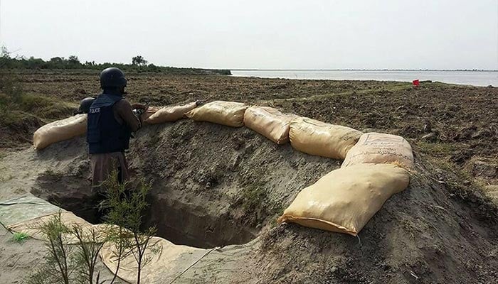 A policemen stands in a bunker as he takes part in an operation against criminals in Rajanpur district in southern Punjab province. — AFP/File