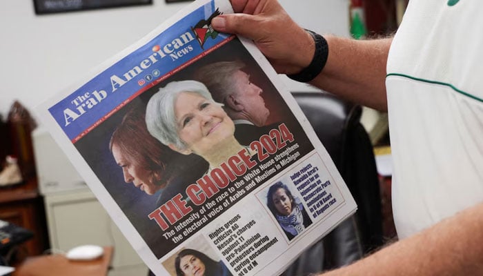 The Arab American News publisher Osama Siblani shows the newspaper cover with the lead story of the electoral voice of Arabs and Muslims in Michigan in Dearborn, Michigan, US on September 18, 2024. — Reuters